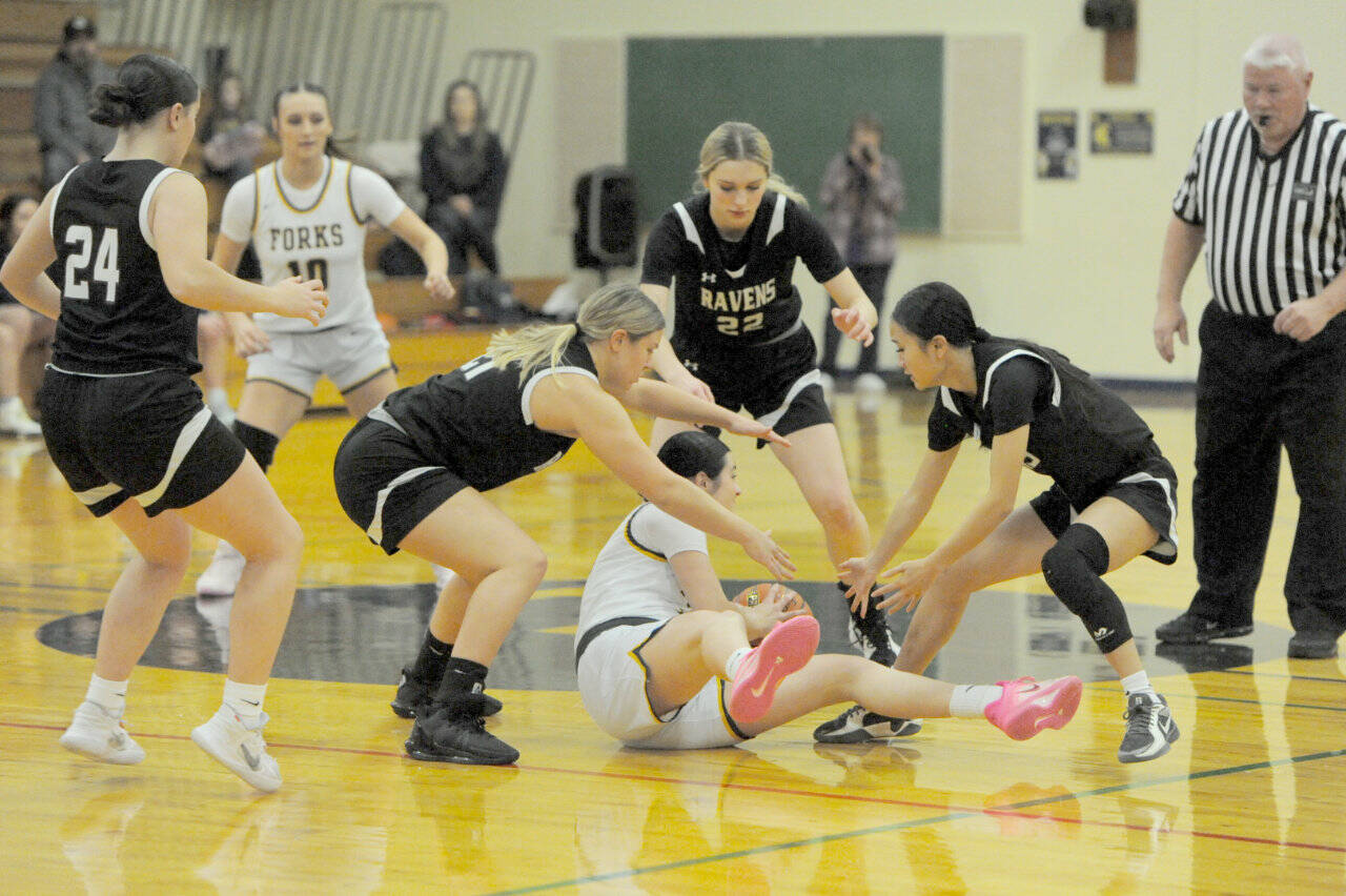 It was a fast moving game between Forks and Raymond-South Bend on Tuesday in Forks. The Spartans defeated RSB 49-42. Here, Forks’ Chloe Gaydeski looks for an outlet while surrounded by Ravens from left, Avalyn Stigall, Kassie Koski, Ava Baugher and Megan Kongbouakhay. Looking on is Forks’ Avery Dilley. (Lonnie Archibald/for Peninsula Daily News)
