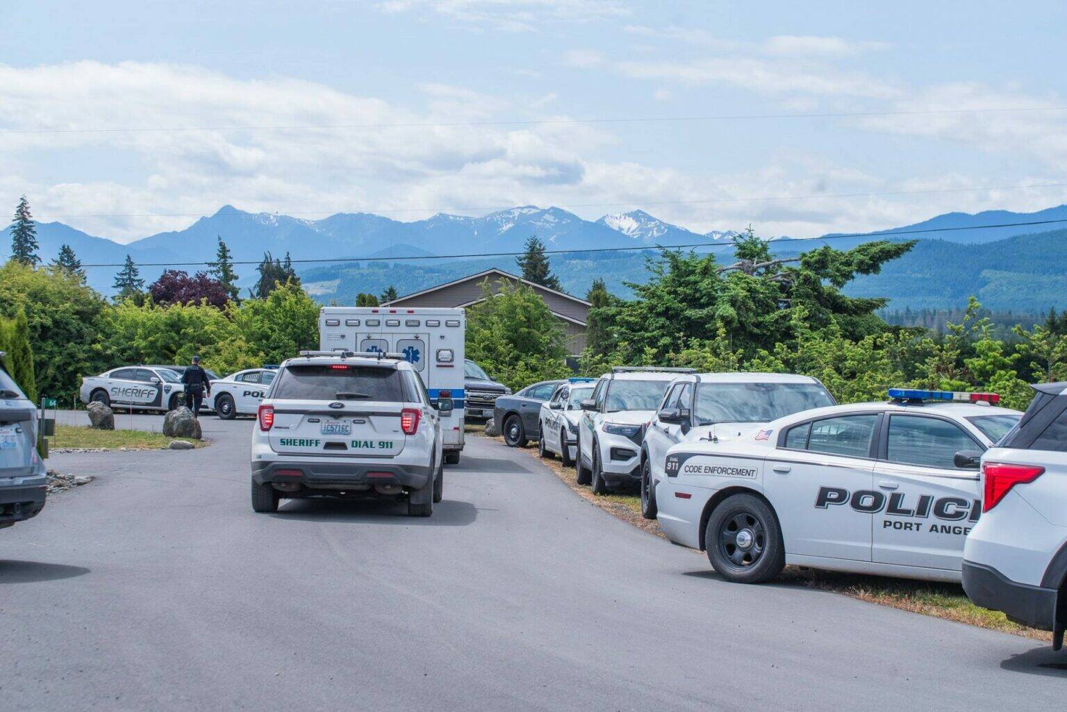 Dozens of law enforcement vehicles assisted with the arrest of Justin Cox last June after he allegedly shot at officers and bystanders as he was sheltering inside a home. On Dec. 22, he received an order for civil commitment for inpatient psychiatric treatment. (Emily Matthiessen/Olympic Peninsula News Group)