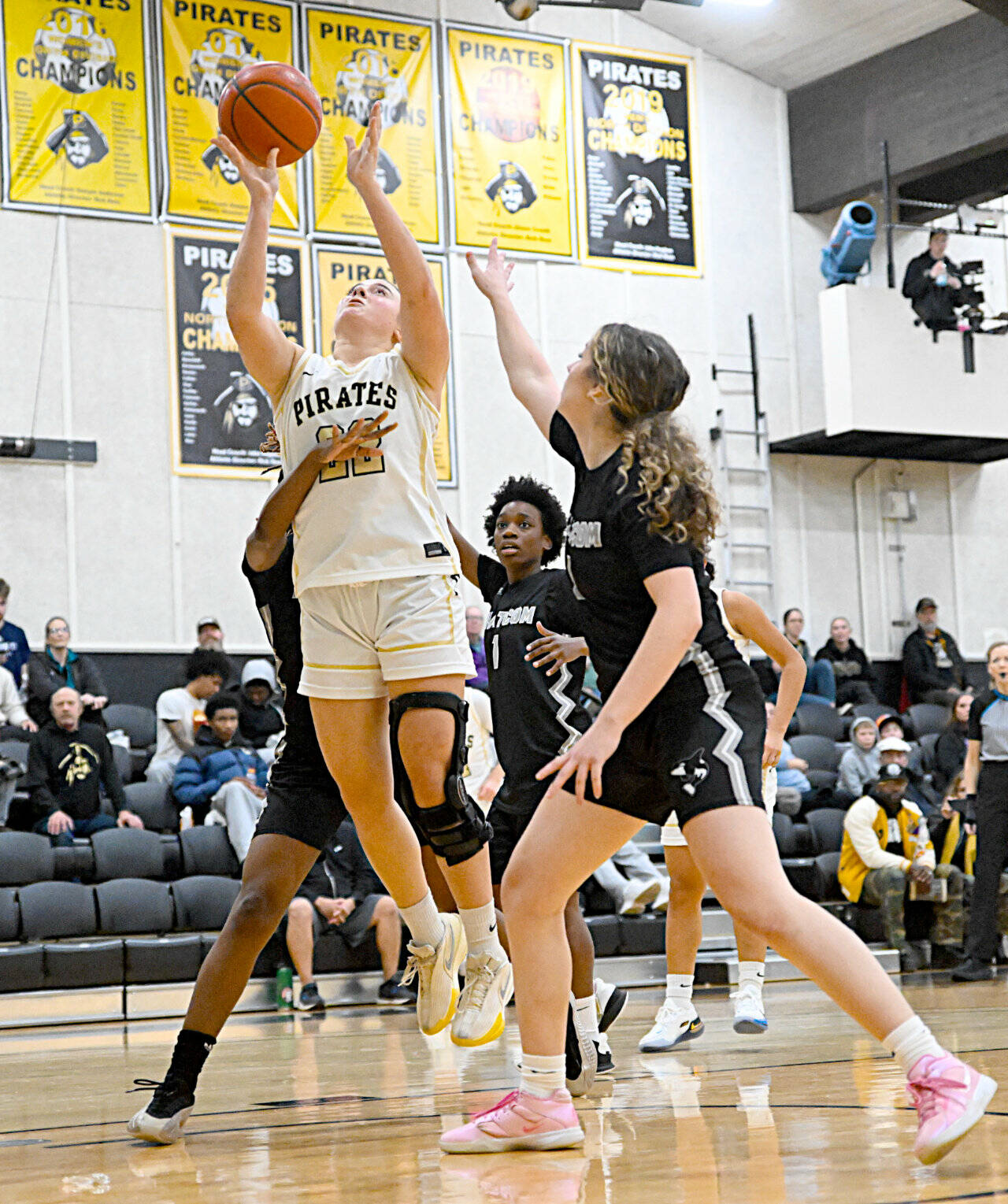 Peninsula College’s Makena Patrick (22) is surrounded by Whatcom players in the paint Saturday in Port Angeles. Patrick had 16 points and 12 rebounds in a 83-46 Peninsula win. (Jay Cline/Peninsula College)