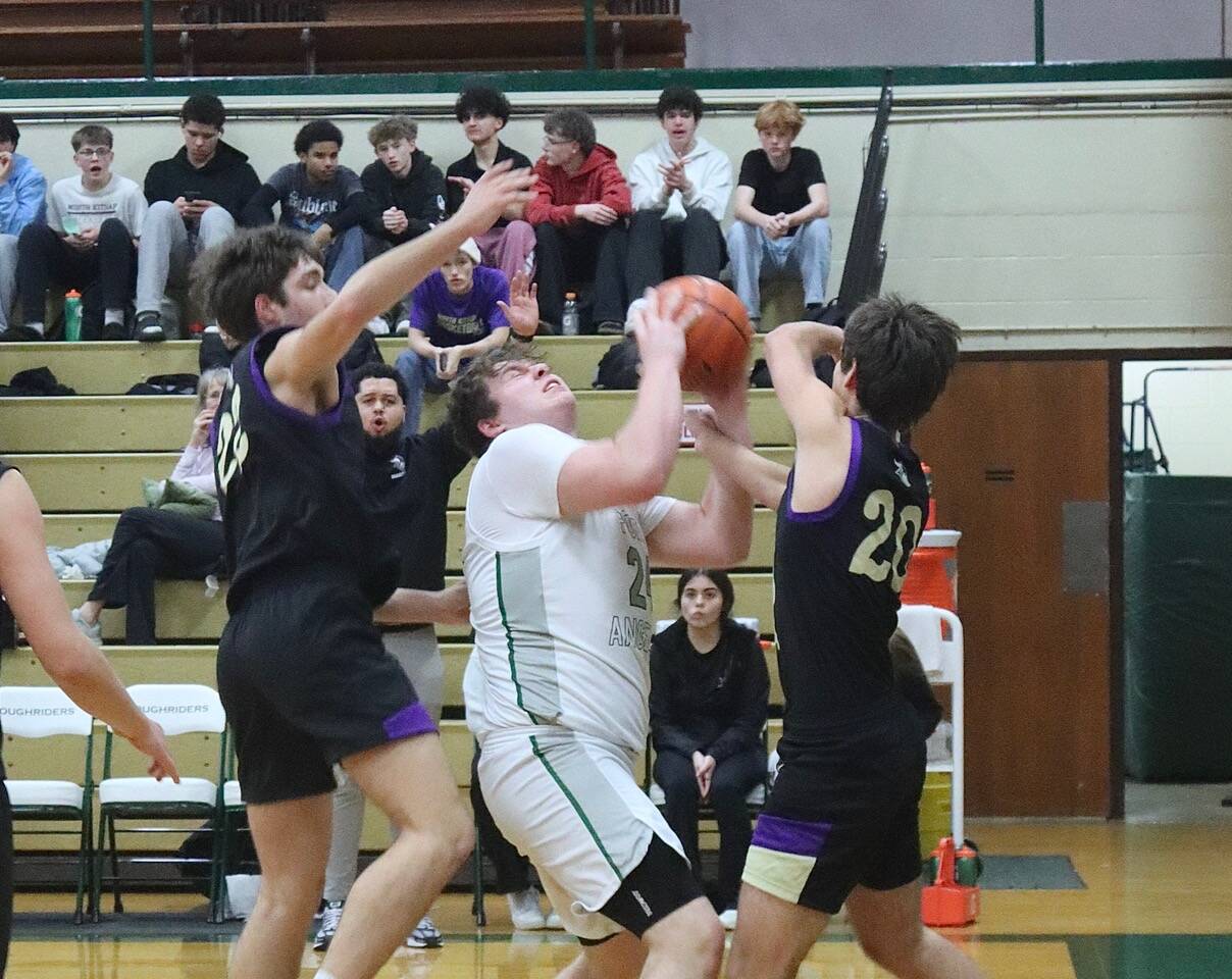 Dave Logan/for Peninsula Daily News 
Port Angeles’ Brock Hope is defended closely by North Kitsap players during the Roughriders’ 61-47 win at home Wednesday.