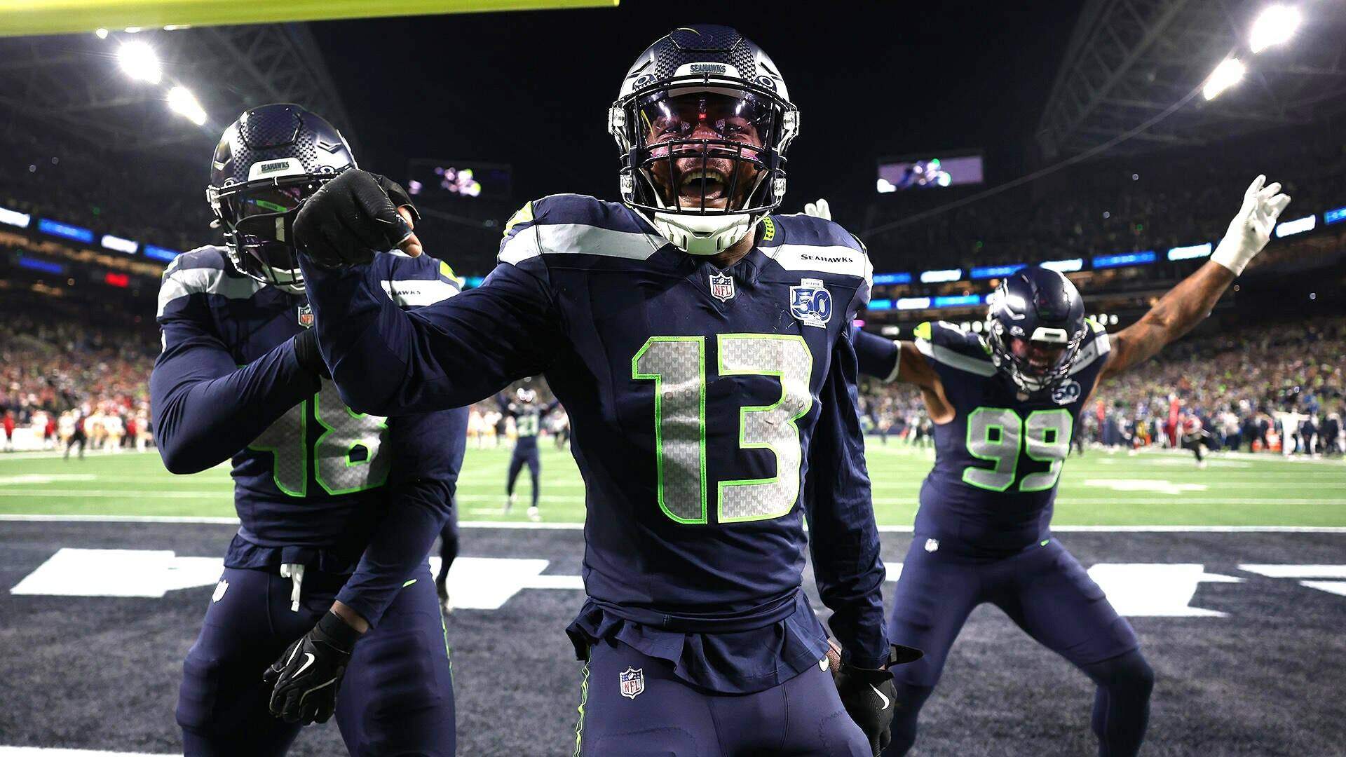 Seattle Seahawks Tyrice Knight (48), Ernest Jones IV (13) and Leonard Williams (99) celebrate during Seattle’s 41-6 NFC divisional playoff victory over the San Francisco 49ers at Lumen Field on Saturday night. (Getty Images)