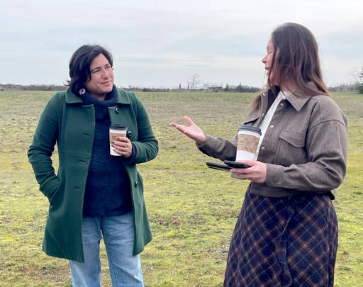 U.S. Rep. Emily Randall, D-Port Orchard, who represents Washington’s 6th Congressional District, left, listens as Lower Elwha Klallam Tribe cultural manager Carmen Watson-Charles explains the history and background of the Tse-whit-zen village located on the west end of Port Angeles Harbor. Randall secured federal funding that will support its preservation. (Paula Hunt/Peninsula Daily News)